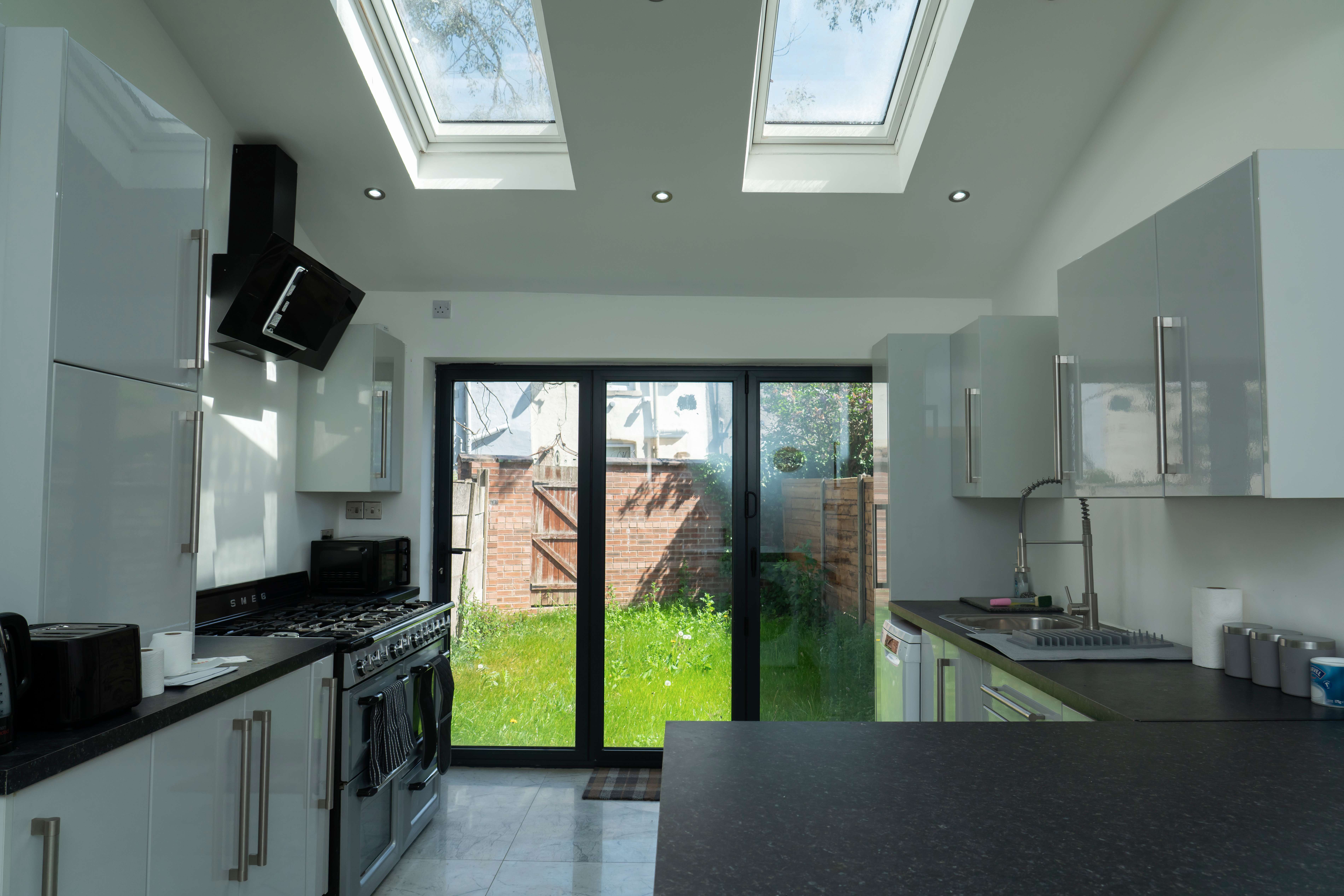 Modern fully equipped kitchen with skylights and garden access